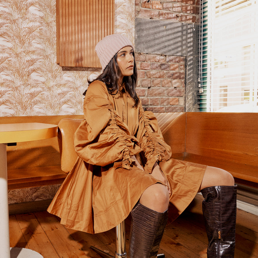 Model, Tessa Edwards, wears the Tucker Beanie in Sand in Gum's front room, Collingwood, Melbourne